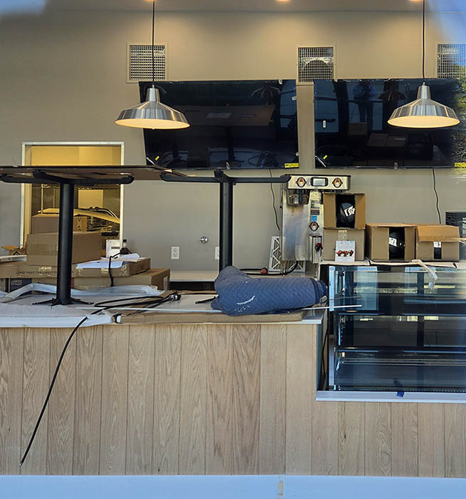 A counter with some tables on top and lights above